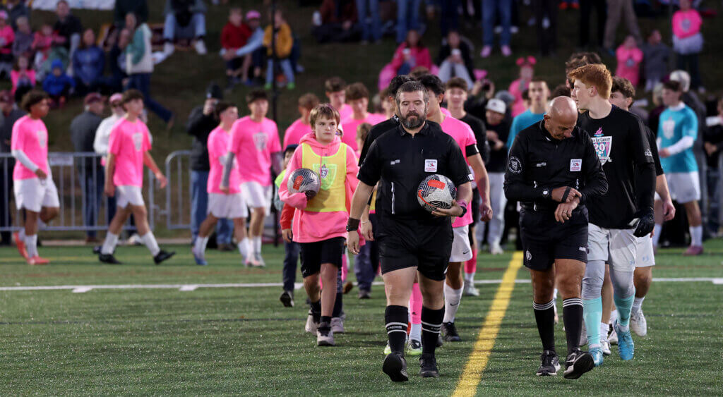 Officials and players take the field.
