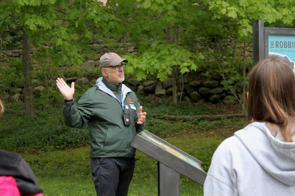 Acton tour guide and Black Heritage Trail Markers project co-lead Joe Palumbo talks to tourists outside the Robbins House museum. Photo: Dakota Antelman/The Acton Bridge