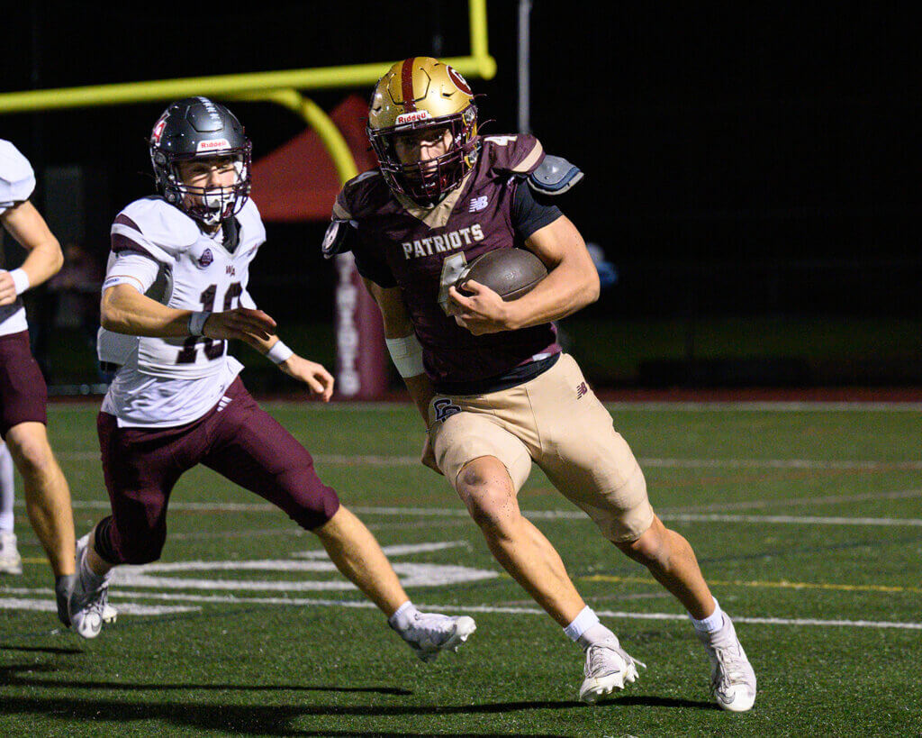 Acton-Carlisle running back Thomas Bury (No. 4) runs 95 yards for the Patriots’ lone score against Westford Academy on October 16. Photo by Jon Straggas