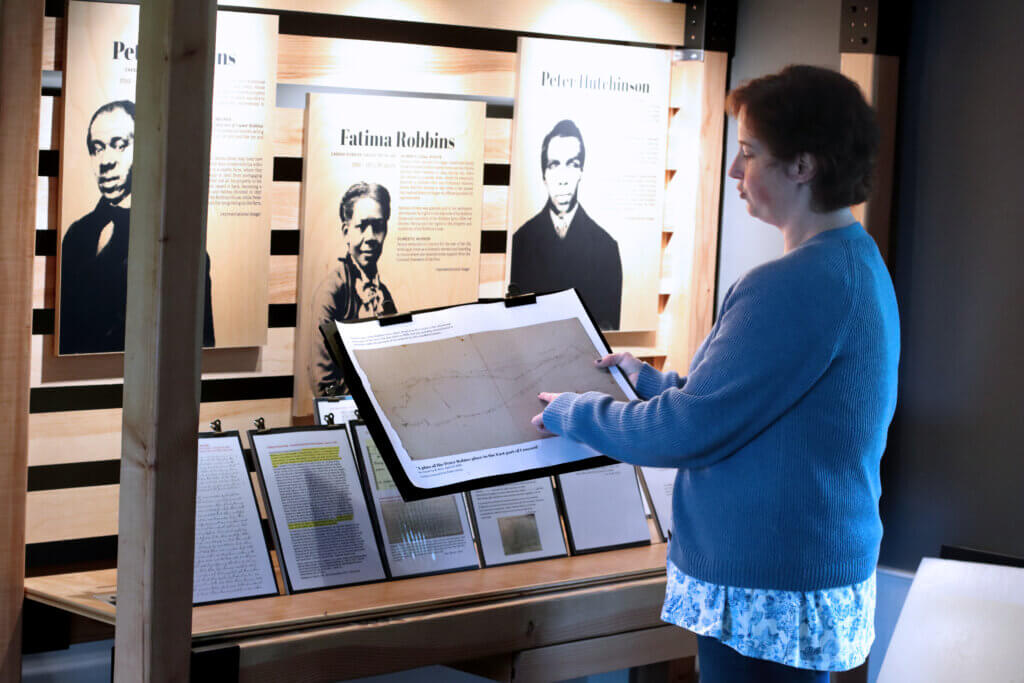 Jen Turner shows a map of the original Robbins House property. Photo: Trace Salzbrenner/The Acton Bridge