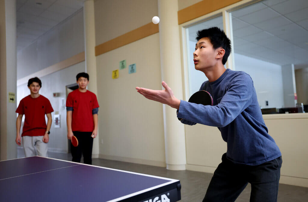 Acton-Carlisle junior Lucas Tang, one on three players in his True Moo Pong Ping team, serves up the ball during the Lunar New Year ping pong tournament at Acton-Carlisle High School on Saturday, February 7, 2026. Ken McGagh/The Acton Bridge