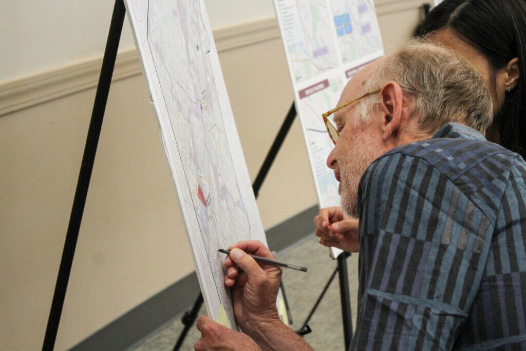 Concordian Jay Copeland marks a poster during a prison redevelopment feedback session. Photo: Dakota Antelman/The Acton Bridge