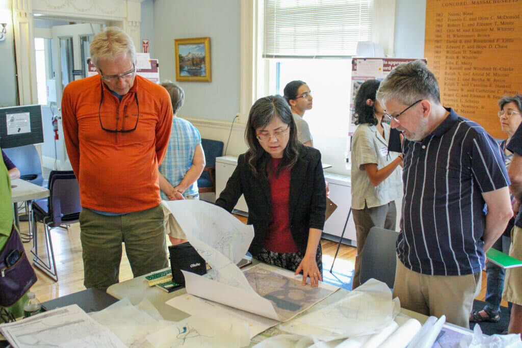 Residents Tom Tremblay, left, and David Karr, right, review prison maps with a consultant. Photo: Dakota Antelman/The Acton Bridge