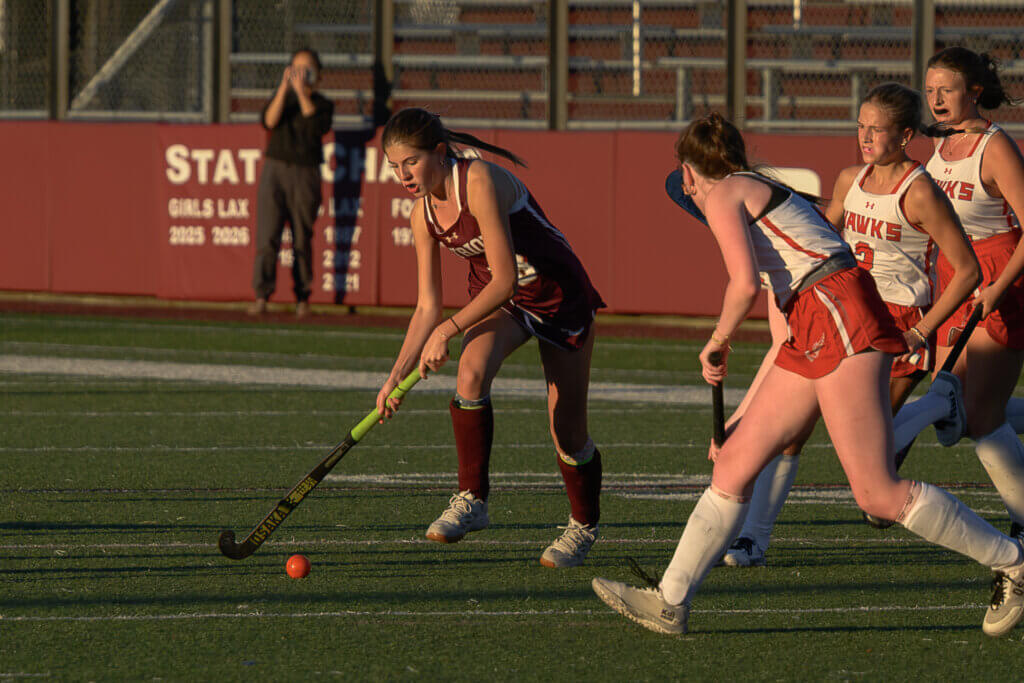 CCHS’ Caroline Connolly confronts a trio of Waltham Hawks on October 5. 