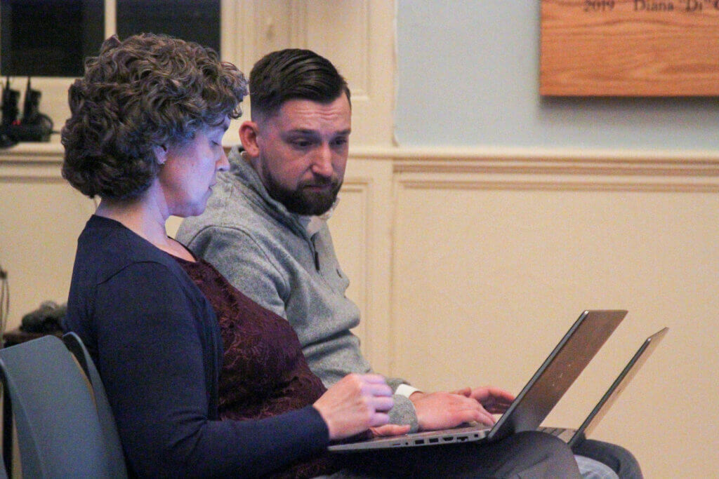 Chief Financial Officer Jennifer Barrett discusses details on her computer with town Senior Financial Analyst Zach Lamoureux. Photo: Dakota Antelman/The Acton Bridge