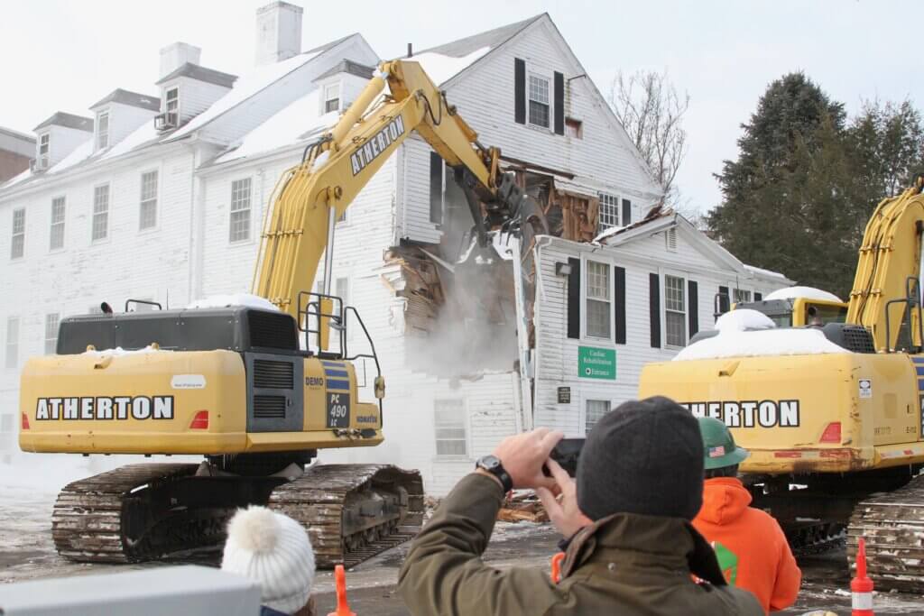 Emerson staff — including Vice President of Development and Chief Philanthropy Officer Karl Kussin, center — photograph the demolition. Photo: Dakota Antelman/The Acton Bridge
