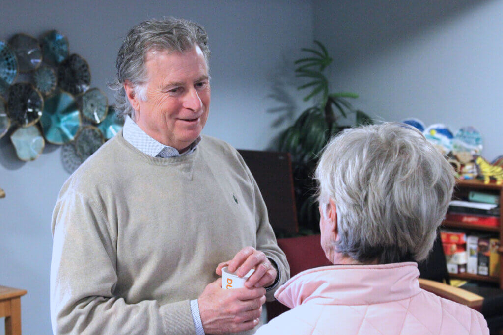 Select Board candidate Joe Laurin speaks with a voter at Peter Bulkeley Terrace during a March 27 housing authority meet-and-greet. Photo: Dakota Antelman/The Acton Bridge