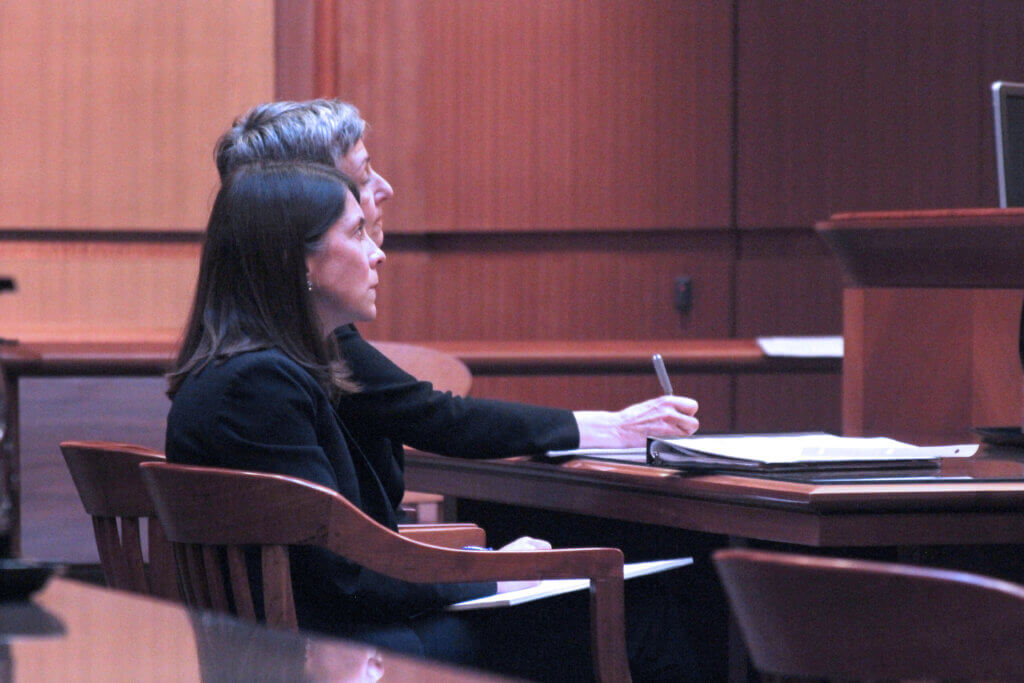Attorney Gwen Nolan King, left, representing the defendants, listens in court. Photo: Dakota Antelman/The Acton Bridge
