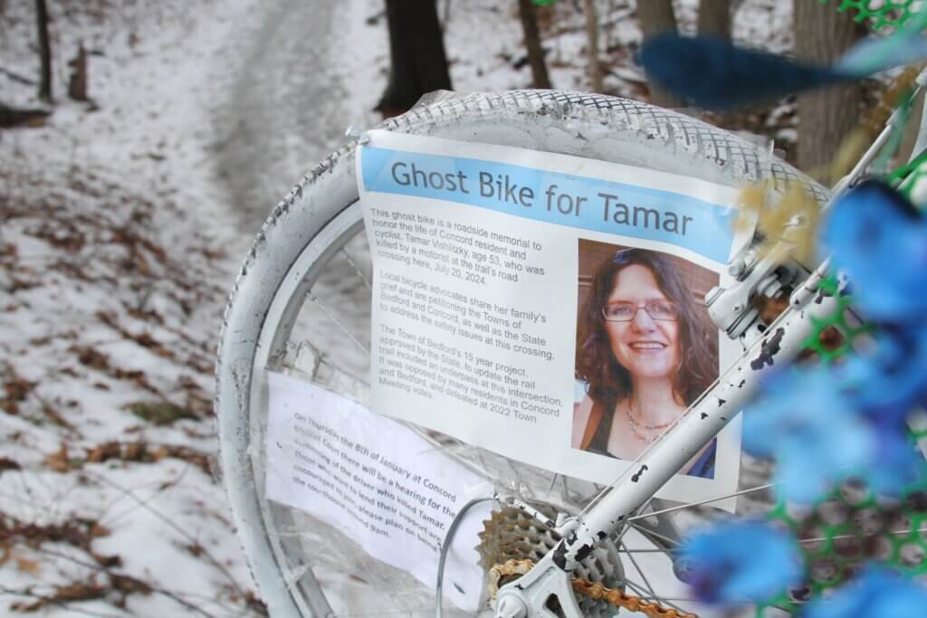 A sign on a memorial “ghost bike” shares information about Tamar Vishlitzky and bike safety advocacy at the intersection where she died. Photo: Dakota Antelman/The Acton Bridge
