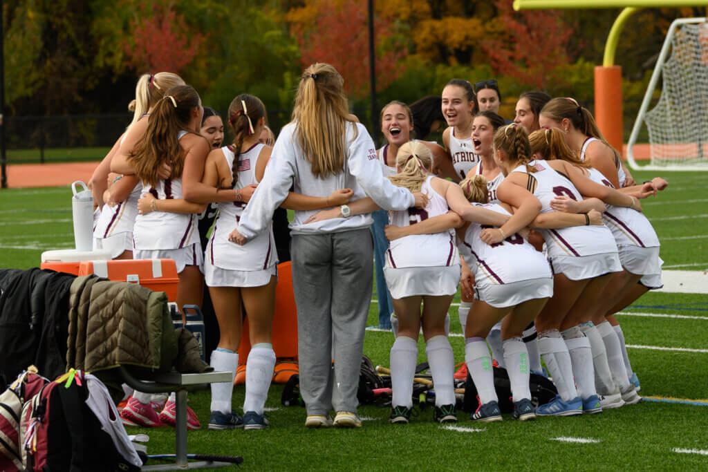 The Acton-Carlisle field hockey team prepares for its October 16 game against Wayland with a group cheer. Photo by David Clancy