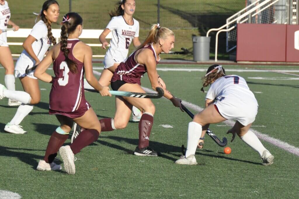 Scarlett Mirak weaves through the Warriors. Photo by David Clancy