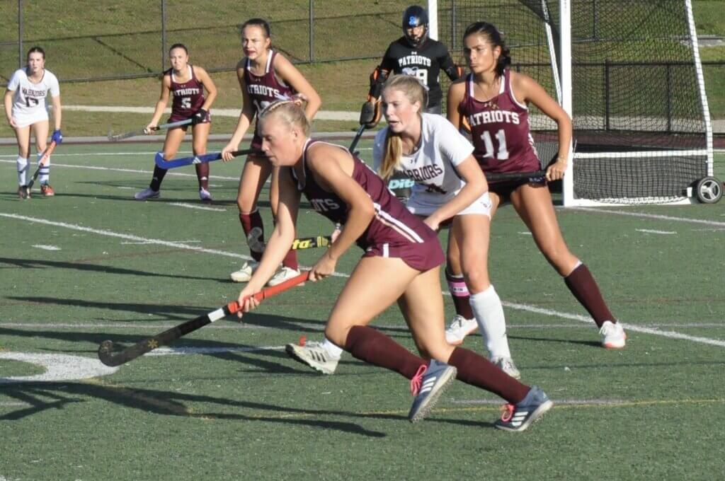A team effort: Lindsay Cain, supported by co-captain Kaia Triola, Zoë Bonzagni, goalie Lexie Ramirez, and Maddie Clancy. Photo by David Clancy