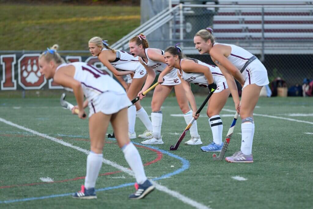 Patriots Bridget Fivek, Julia Reynolds, co-captain Ally Couto, Abby Ruhmann, and Lindsay Cain stare down the Lions. Photo by David Clancy