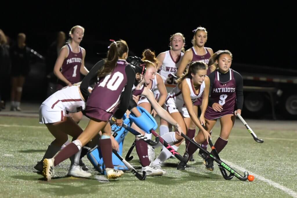 The swarming Patriots force Weston to fight for every inch of turf. Photo by David Clancy