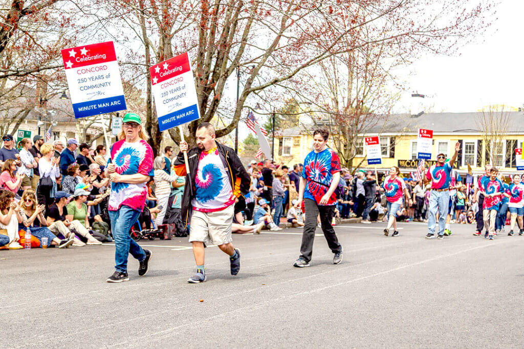 A group from Minute Man Arc, which serves children and adults with disabilities, hit the parade route in eye-catching tie-dye tops. Photo: Stephen Beyer/The Acton Bridge
