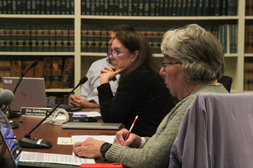 FinCom’s Peggy Briggs takes notes during the panel’s preliminary guideline deliberations. Photo: Dakota Antelman/The Acton Bridge