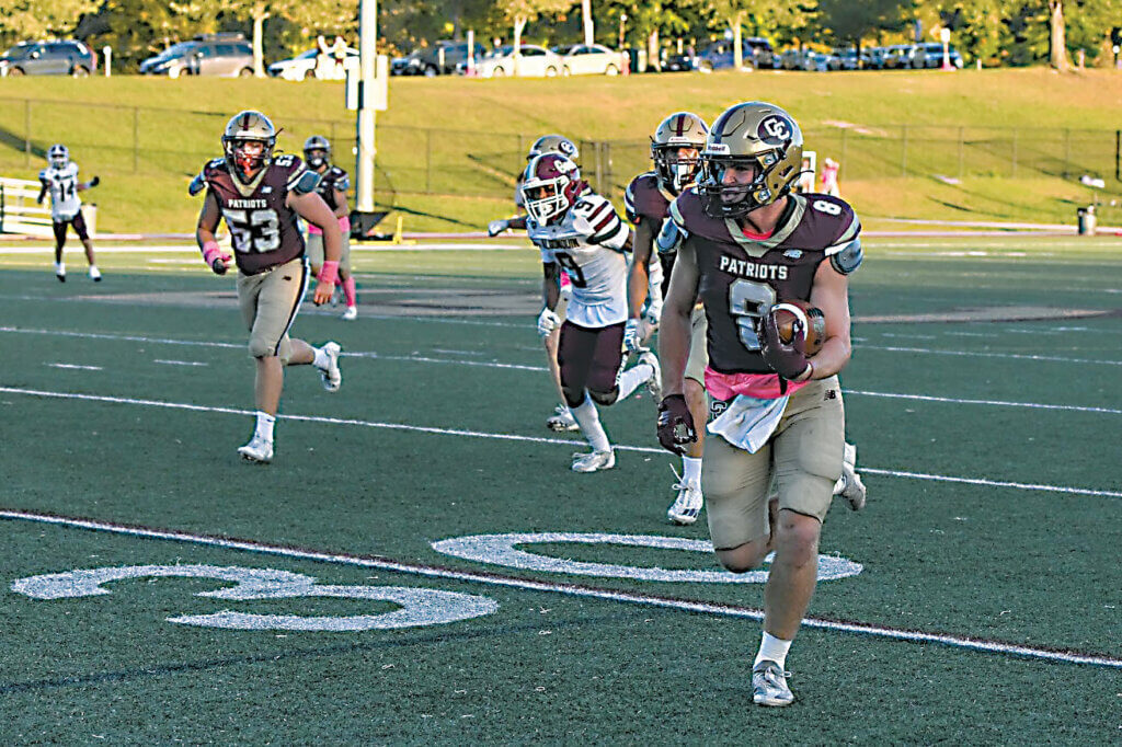 Wes Morse leaves the Titans in his wake as he speeds to the end zone. Photo by Cris Van Dyke
