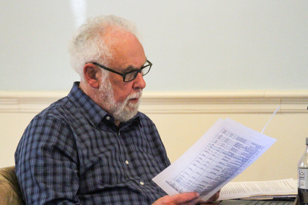 Select Board member Paul Boehm reviews notes before the group’s April 13 meeting. Photo: Dakota Antelman/The Acton Bridge