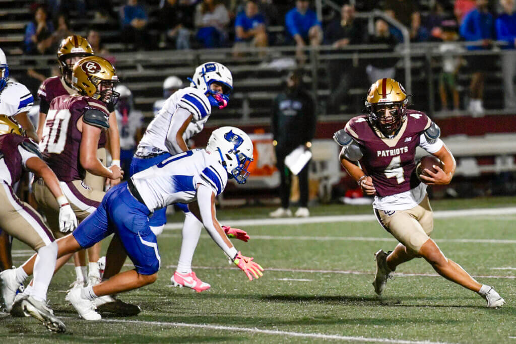 Patriots running back Thomas Bury picks up yardage against Bedford on October 2. Photo by Cris Van Dyke