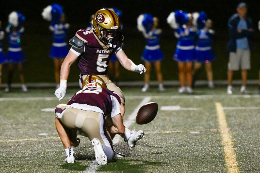 Jack Garofalo kicks an extra point with Ryan Duffy holding during the game against Bedford on October 2. Photo by Cris Van Dyke