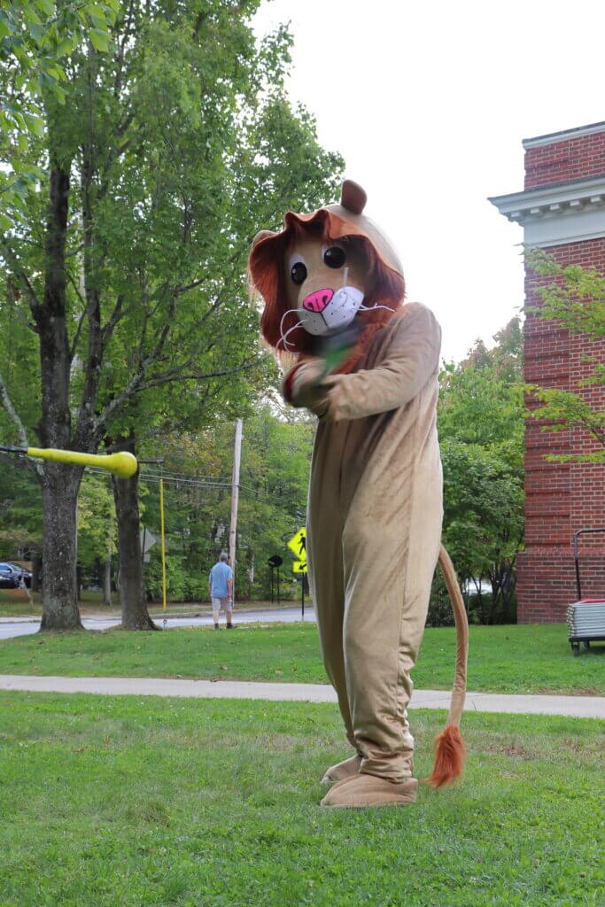 The Lions Club mascot tries out beep baseball. A loud buzzer signals when to swing and which base to run to, enabling the visually impaired to play baseball. Photo: Trace Salzbrenner/The Acton Bridge