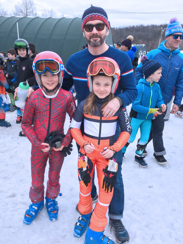Henry and Juniper Flint with their father and coach, Burton, at a 2019 race. Photo courtesy of Jen Flint
