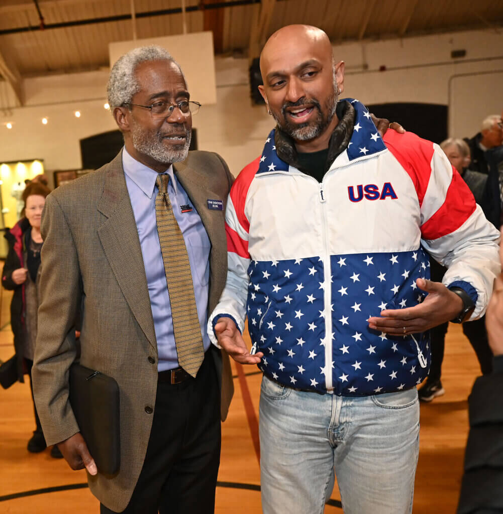 Michael Williams, left, and Sandeep Pisharody celebate at the Acton Armory after winning seats on the School Committee and defeating an incumbent on Tuesday, April 8, 2025. Ken McGagh/The Acton Bridge