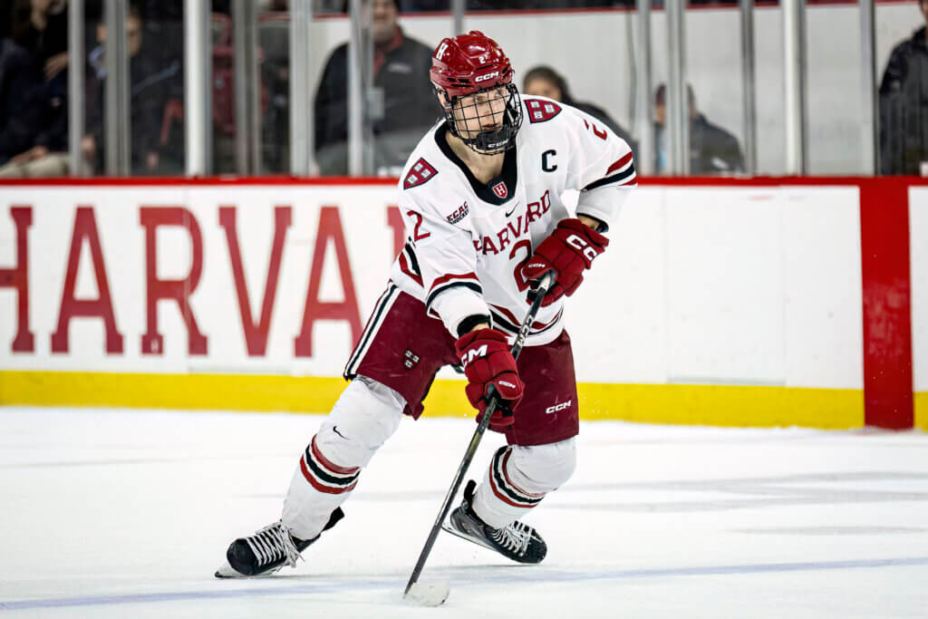 Ian Moore on the ice as the captain of the Harvard Crimson men’s hockey team. Photo courtesy of Harvard University Athletics