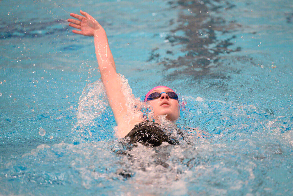 Polly Curran does the backstroke on the way to her third-place finish in the 200-yard individual medley. Photo by Jon Straggas