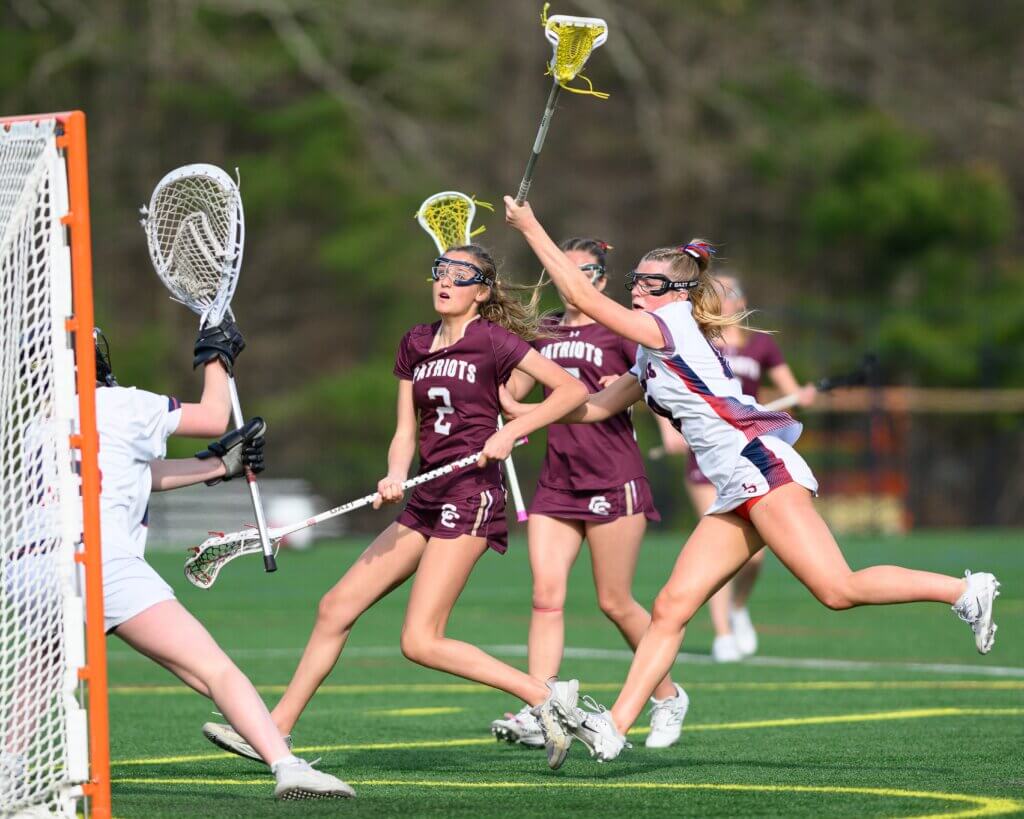 Acton-Carlisle’s Bridget Fivek (No. 2) pressures the Lincoln-Sudbury defense in a tense contest on April 16. Photo by Jon Straggas