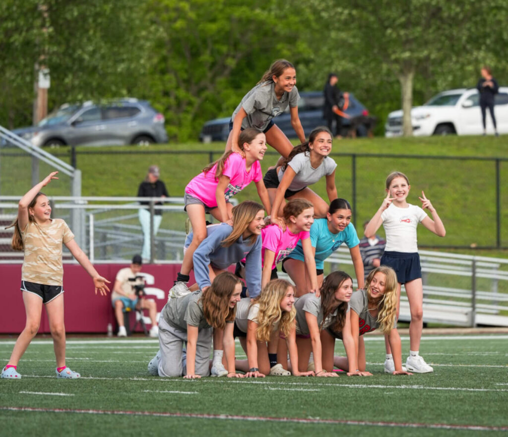 The girls were cheered on by the sixth grade lacrosse team, which went out onto the field and formed a pyramid of support. Photo by Aidan Moroney
