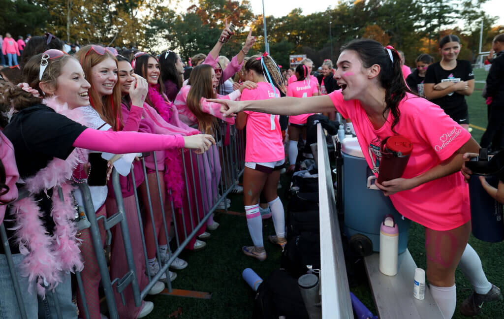 Acton-Carlisle fans greet Holden Taunton-Rigby, right, and other players after the big win.