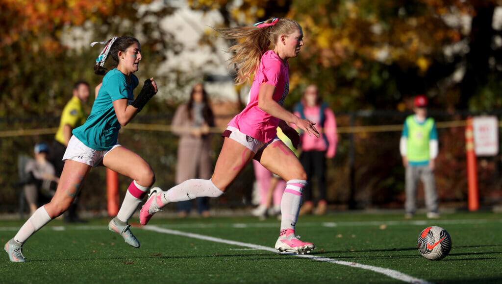Acton-Carlisle’s Ainsley Siefer, right, drives toward the Lincoln-Sudbury net during the first half.