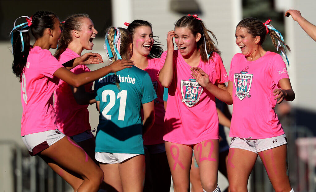 Teammates mob co-captain Emmy O’Donnell, right, after she scored the game’s second goal.