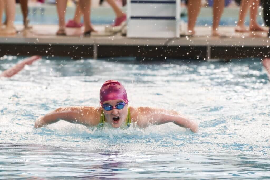 Girls co-captain Rosie Mowat swims the 100-yard butterfly Saturday at the Beede Swim and Fitness Center. Photo by Kate Renyi