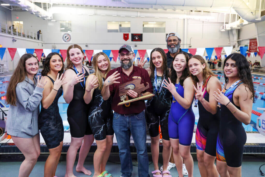 CCHS class of 2026 senior swimmers flash four fingers to celebrate their fourth straight North Sectionals championship. From left: Rosie Mowat, Isabella Rameriz, Bea Turrettini, Phoebe Renyi, Head Coach Matt Goldberg, Sarah Nadzo, Assistant Coach Jerry Moss, Hana Baldini, Sarah Fortier, and Mena Sheth. Photo by Kate Renyi