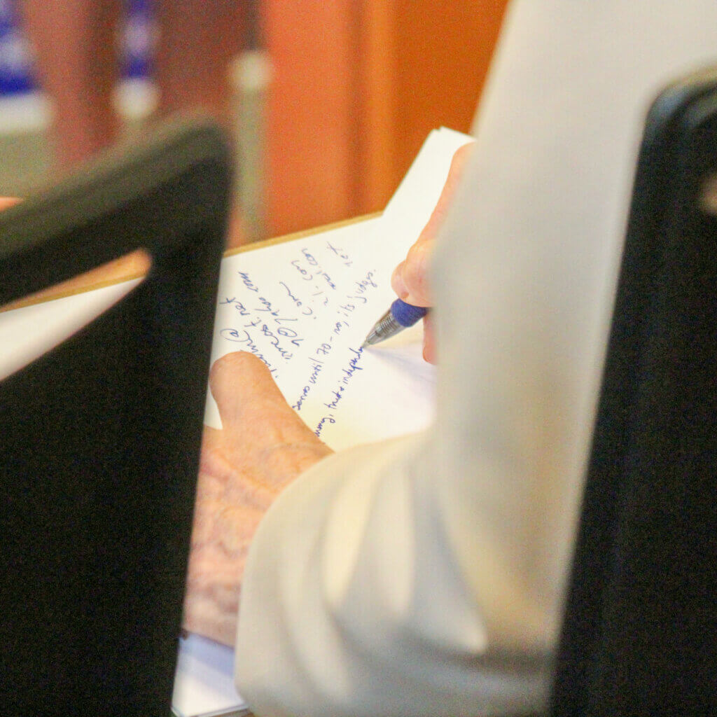 Governor’s Council incumbent Mara Dolan takes notes while opponent Margie Palladino speaks. Photo: Dakota Antelman/The Acton Bridge