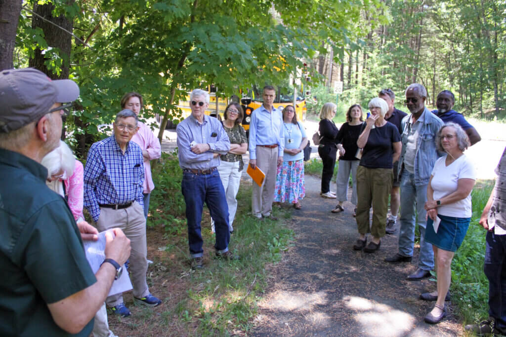 Bus tour attendees gather near the Bruce Freeman Rail Trail in West Acton. Photo: Dakota Antelman/The Acton Bridge