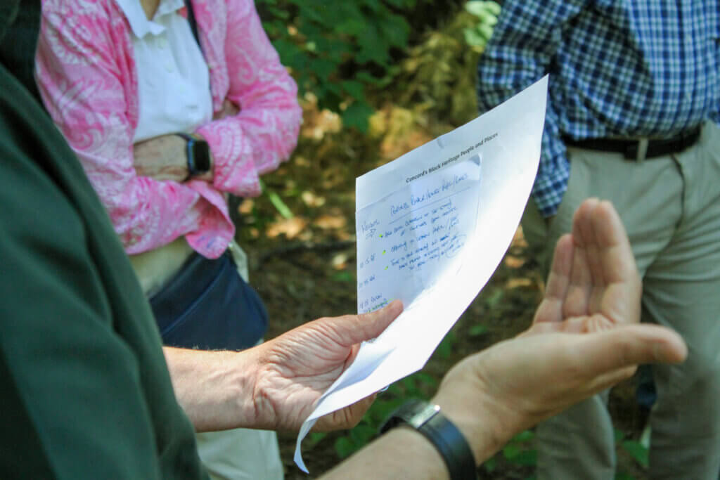 Black Heritage Trail Markers project co-lead Joe Palumbo kept notes for a tightly planned bus tour last week. Photo: Dakota Antelman/The Acton Bridge