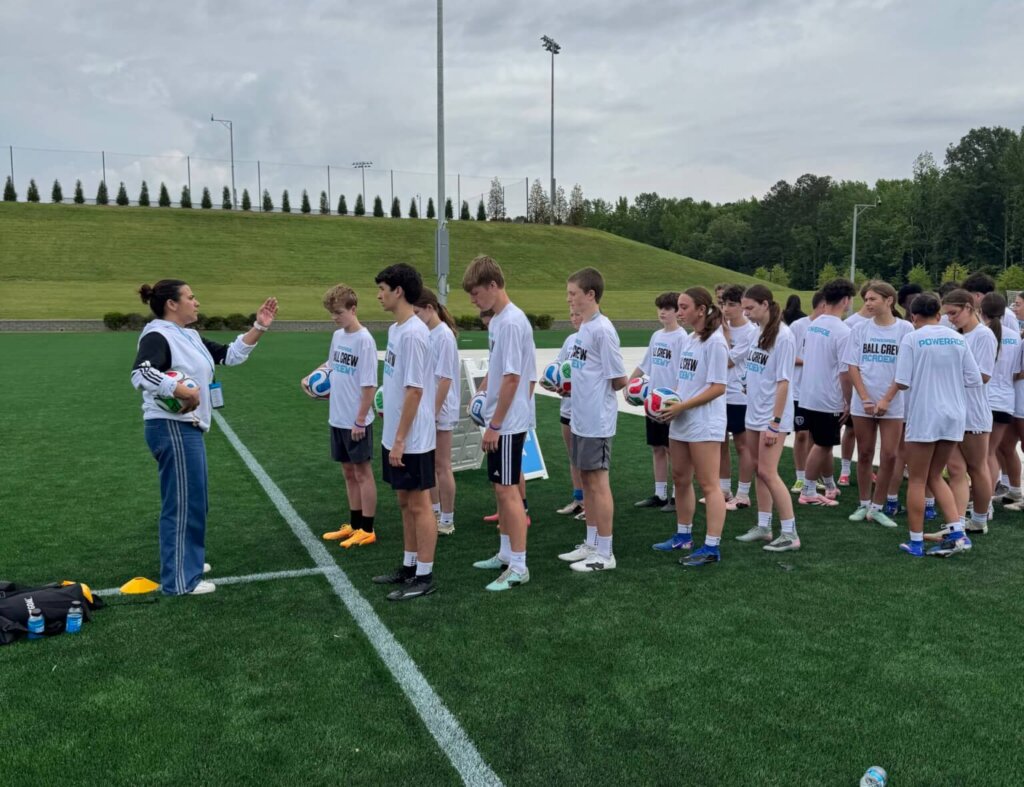 The ball crew trains with a FIFA representative. Photo by Laura Hutchinson