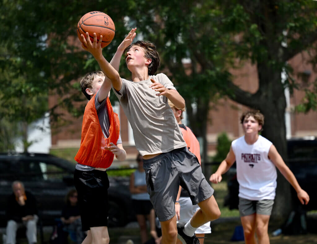 Theo Kamon, 14, a rising freshman at Acton-Carlisle High School, shoots for two during a one-day 3v3 basketball tournament to raise money and awareness for NMDP, formerly known as the National Marrow Donor Program, a non-profit that manages a global bone marrow registry that finds donors for lifesaving bone marrow transplants, at Emerson Playground on Saturday, July 26, 2025. $3,100 was raised Saturday. Ken McGagh/The Acton Bridge