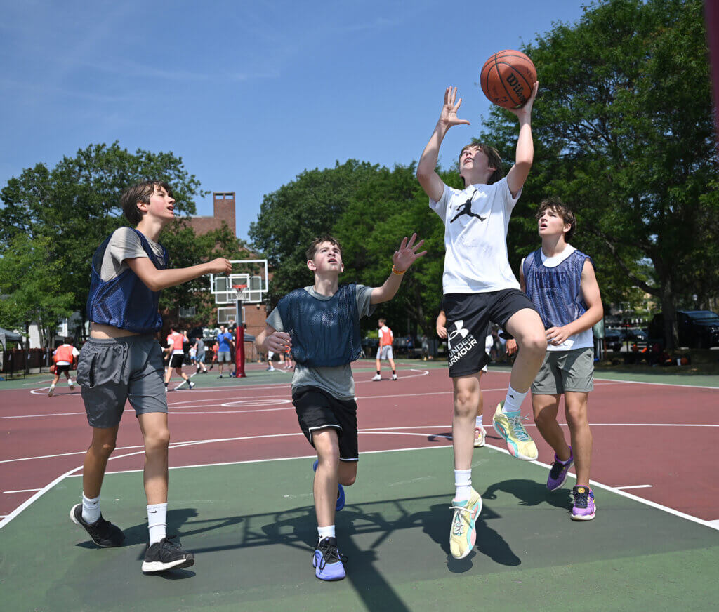 Will Pisapia, 14, drives to the hoop during a one-day 3v3 basketball tournament to raise money and awareness for NMDP, formerly known as the National Marrow Donor Program, a non-profit that manages a global bone marrow registry that finds donors for lifesaving bone marrow transplants, at Emerson Playground on Saturday, July 26, 2025. Ken McGagh/The Acton Bridge