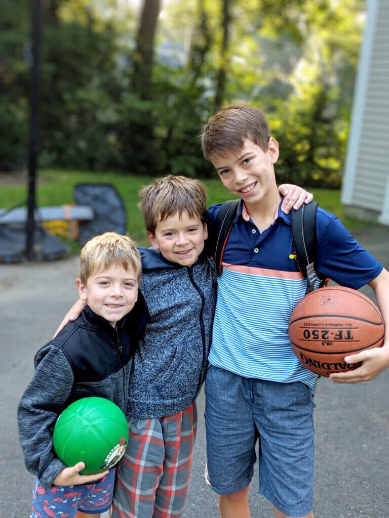 Graham, 5, Ewan, 9, and Cal, 11, pause for a photo during a 2019 driveway basketball game. Courtesy photo