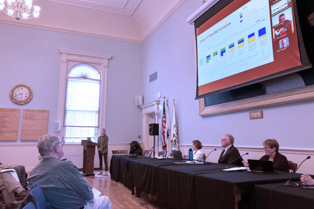 Mary Hartman, right, and Keith Bergman, second from right, listen to a speaker during a May 19 meeting of housing leaders. Photo: Dakota Antelman/The Acton Bridge