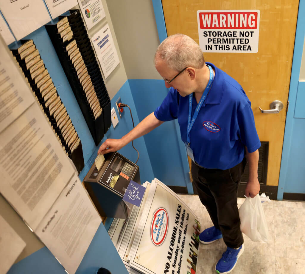 David Inferrera, a thirty-five year veteran at Crosby’s Marketplace, punches in for his shift on Friday, July 31, 2026. Ken McGagh/The Acton Bridge