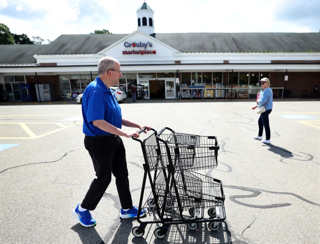 David Inferrera, a thirty-five year veteran at Crosby’s Marketplace, collects shopping carts in the parking lot on Friday, July 31, 2026. Ken McGagh/The Acton Bridge
