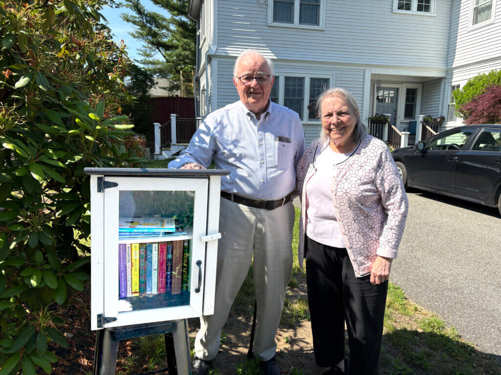 Gerry and Yvette Boyle, with their daughter Susan’s help, are stewards of a Little Free Library on Central Street. Photo: Christine M. Quirk/The Acton Bridge