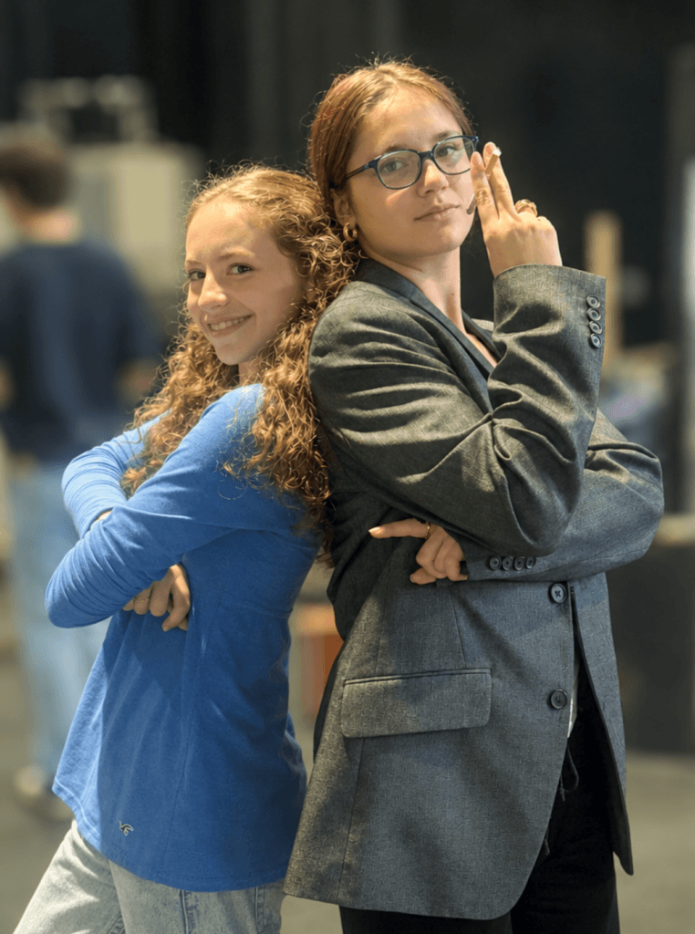 From left, Paloma Wigton as Molly Ralston and Emma Couvillon as Miss Casewell take a backstage break from rehearsal. Photo by Aadya Pathak