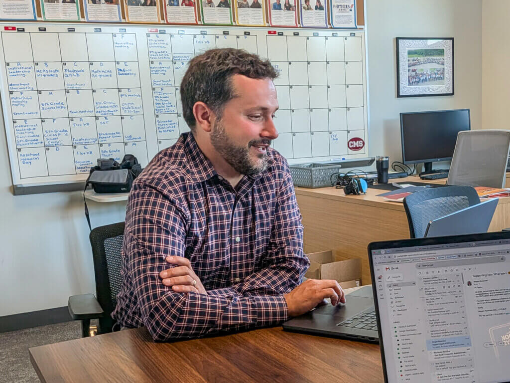 Incoming interim Principal Dan Hausermann speaks with Justin Cameron. Photo: Trace Salzbrenner/The Acton Bridge