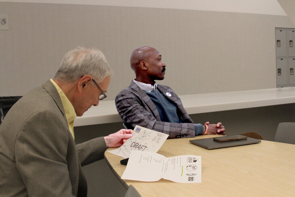 Concord250 Executive Committee co-chair Gary Clayton (left) reviews a planning document during a joint meeting with 250th anniversary organizers from other area towns. Photo: Dakota Antelman/The Acton Bridge